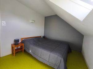 a bedroom with a bed and a small table at Gite la Borie de Pourtou Santoire in Condat
