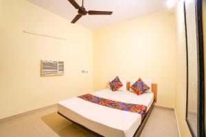 a bedroom with a bed in a room at FabHotel Mara Residency in Chennai