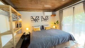 a bedroom with a bed and a bunk ladder at Ghxabara Cozy Cabin in Maun +24 photos