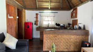 a kitchen with a red refrigerator in a room at Ghxabara Cozy Cabin in Maun