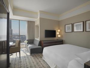 a hotel room with a bed and a television at Jabal Omar Hyatt Regency Makkah in Mecca