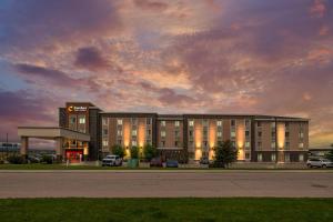 a building with a gas station in a parking lot at Comfort Inn & Suites Airport North in Calgary