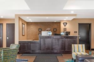 a hotel lobby with a reception desk and chairs at Comfort Inn & Suites Airport North in Calgary +44 photos