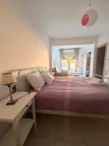 a bedroom with a bed and a desk and a window at The nest in Kalavrita