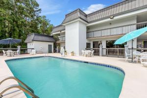 a swimming pool in front of a house at Quality Inn Walterboro I-95 in Walterboro