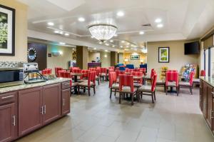 a restaurant with red chairs and tables in a room at Comfort Inn Ottawa Kansas in Ottawa