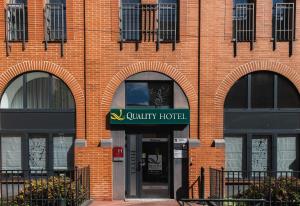 a brick building with a sign for a qualify hotel at Quality Hotel Toulouse Centre in Toulouse