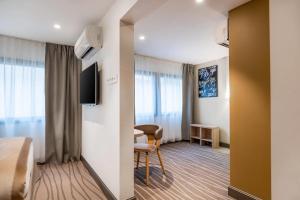 a hotel room with a bed and a chair and a table at Quality Hotel Toulouse Centre in Toulouse +36 photos