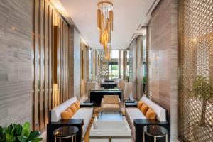 a lobby of a hotel with couches and tables at Meliá Vinpearl Thanh Hoa in Thanh Hóa