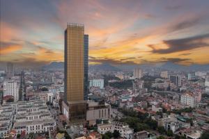 a tall building in a city at sunset at Meliá Vinpearl Thanh Hoa in Thanh Hóa