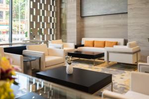 a living room with a couch and chairs and a table at Meliá Vinpearl Thanh Hoa in Thanh Hóa +62 photos