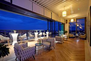 a restaurant with a view of the city at night at Meliá Vinpearl Thanh Hoa in Thanh Hóa