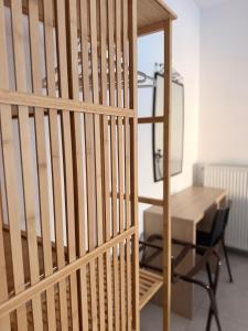 a wooden crib in a room with a desk at The nest in Kalavrita +3 photos