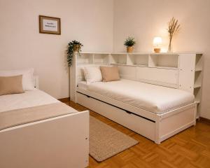 a bedroom with two beds with white shelves at Odw homes - Wohnung im Landhaus mit Garten in Trösel