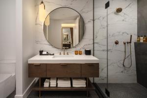 a bathroom with a sink and a mirror at Thompson Houston, by Hyatt in Houston