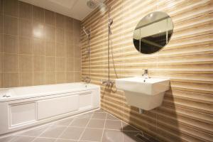 a bathroom with a sink and a tub and a mirror at Ulsan Seongnam Hotel Mar in Ulsan +36 photos