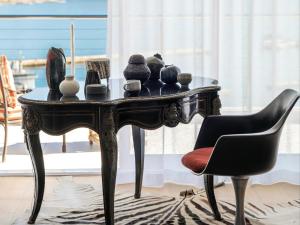 a table with vases on it with two chairs at The Lighthouse in Simonʼs Town