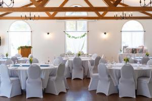 a room with white tables and white chairs at Isaiah Tubbs Resort & Conference Centre in Picton +68 photos