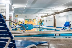 a swimming pool with a mural on the wall at Hotel Downstreet, an Ascend Collection Hotel in North Adams