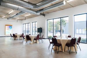 a conference room with tables and chairs and windows at Hotel Downstreet, an Ascend Collection Hotel in North Adams +103 photos
