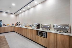 a kitchen with a counter with a microwave at Sleep Inn & Suites Henderson - Las Vegas in Henderson