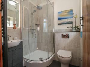 a bathroom with a shower and a toilet and a sink at Sunnyside in Weston-super-Mare +19 photos