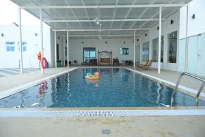 an indoor swimming pool with a toy in the water at Al Miqyal Resort - استراحة المقيال - الساد in Al Ain