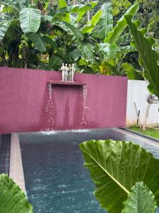 two people standing on top of a water fountain at Palace Bope Galle in Galle