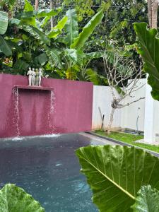 a fountain with two statues on the side of a road at Palace Bope Galle in Galle