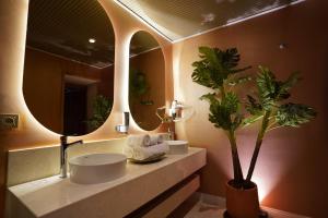 a bathroom with two sinks and a large mirror at Gülten Hanım Konağı in Gaziantep +43 photos