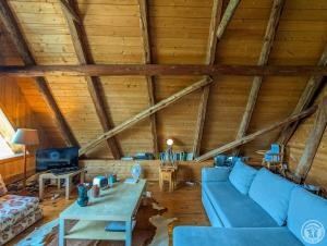 a living room with a blue couch and a table at La grange de martine in Saccourvielle