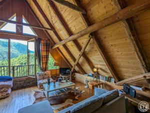 a living room with a couch and a table at La grange de martine in Saccourvielle