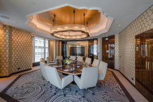 a dining room with a table and white chairs at Matild Palace, a Luxury Collection Hotel in Budapest