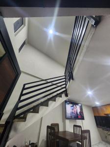 a staircase with a television and a table and chairs at departamento para Hospedaje en zacatlan in Zacatlán