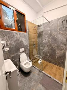 a bathroom with a toilet and a shower at Berat GuestHouse "AAA" in Berat
