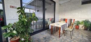 a table and chairs in a room with plants at Berat GuestHouse "AAA" in Berat