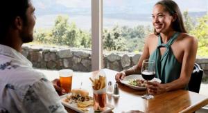 a man and woman sitting at a table with a plate of food at Volcano House in Volcano +4 photos
