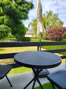 a table and two chairs and an umbrella on a patio at The nest in Malmedy