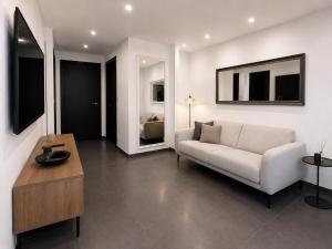 a living room with a couch and a table at Les vacances in Sainte-Maxime