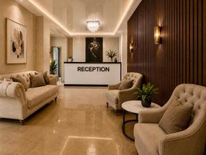 a reception room with couches and chairs and a stage at Golden Fleece Hotel in Ureki +58 photos