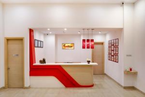 a lobby with a red stripe on the wall at Red Fox by Lemon Tree Hotels, Sector 60, Gurugram in Gurgaon