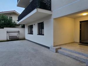 a building with a balcony and stairs next to it at Livia Residence II in Constanţa