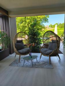 two wicker chairs and a coffee table on a patio at Agriturismo Camerin - CL Agri Lounge in Conegliano