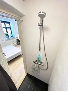 a bathroom with a shower in the corner of a room at Stokbrogade 7 - lejlighed 2 in Hjørring +45 photos