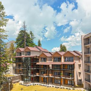 an apartment building with a roof on top of it at Doubletree By Hilton Nathiagali in Nathia Gali