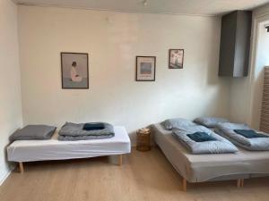 two beds are sitting in a room at Stokbrogade 7 - lejlighed 2 in Hjørring