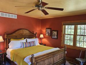 a bedroom with a bed and a ceiling fan at Chanticleer Cabins in Sturgeon Bay