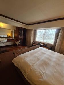 a hotel room with a large bed and a bathroom at Beautiful Hotel Taipei in Xindian +64 photos