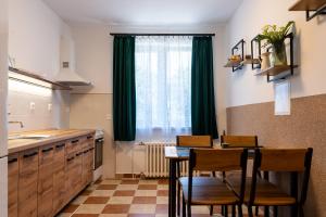 a kitchen with a table and chairs and a window at Green House in Banka
