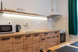 a kitchen with a sink and a microwave on a counter at Green House in Banka +8 photos